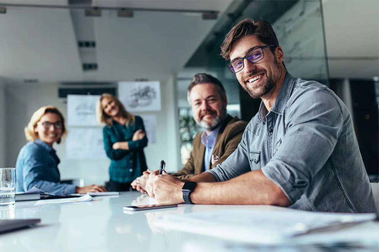 Happy business team smiling, representing professional and affordable custom web design services.